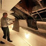Philip J. Kelly peels away part of the ceiling